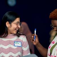 International Anchor Allies Winter 2026 First Mixer - 2 students share a laughter over a game